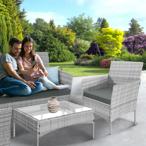 Rattan garden set with lounger, chairs, and table