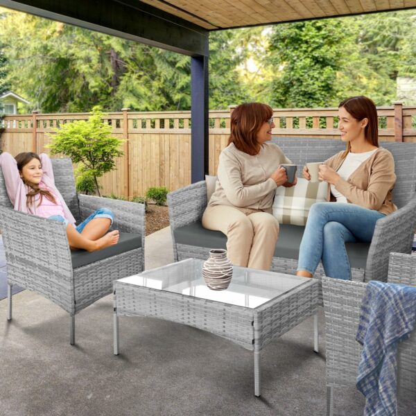 Rattan garden set with lounger, chairs, and table